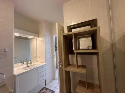 a bathroom with a sink and a mirror at Congress et Comfort in Cannes