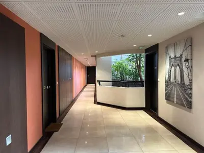 a hallway in a building with a painting on the wall at Congress et Comfort in Cannes
