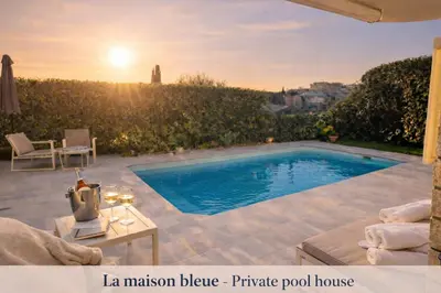 a swimming pool in a backyard with the sunset at Private Pool House , 10min Cannes in Le Cannet