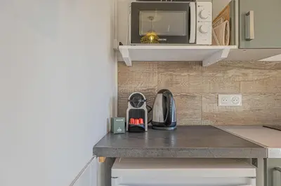 a kitchen with a counter top with a microwave at Studio avec balcon et parking proche plages in Cannes