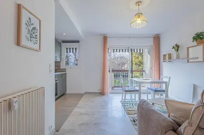 a living room with a couch and a table at Studio avec balcon et parking proche plages in Cannes