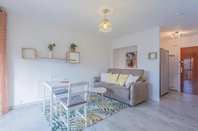 a living room with a couch and a table at Studio avec balcon et parking proche plages in Cannes