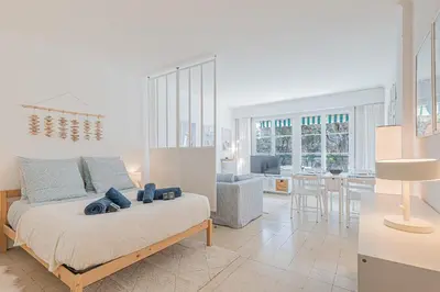 a bedroom with a bed and a living room at Le Bleu Ciel - Studio Croisette idéal congrès in Cannes