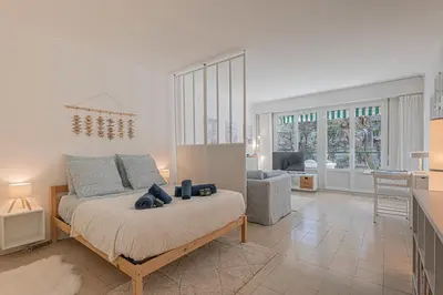 a bedroom with a bed and a living room at Le Bleu Ciel - Studio Croisette idéal congrès in Cannes