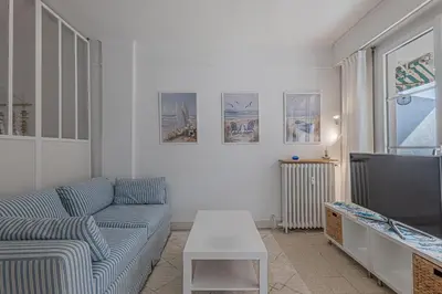 a living room with a couch and a table at Le Bleu Ciel - Studio Croisette idéal congrès in Cannes