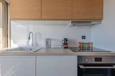 a kitchen with a sink and a counter top at Elégant 2 pièces - accès mer direct vue splendide in Cannes