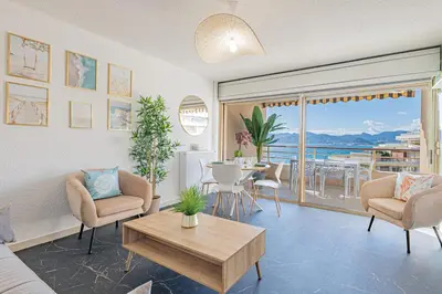 a living room with a view of the ocean at Elégant 2 pièces - accès mer direct vue splendide in Cannes