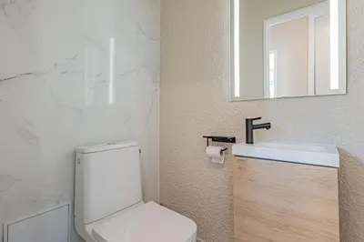 a bathroom with a white toilet and a sink at Elégant 2 pièces - accès mer direct vue splendide in Cannes