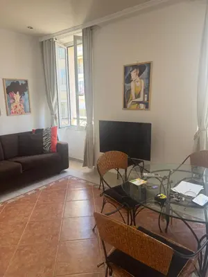 a living room with a glass table and a couch at Premium central Apartment in Cannes