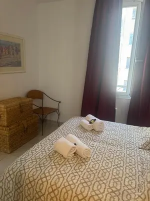 a bedroom with a bed with towels on it at Premium central Apartment in Cannes