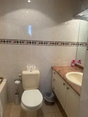a bathroom with a white toilet and a sink at Premium central Apartment in Cannes
