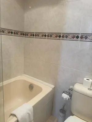 a bathroom with a bath tub and a toilet at Premium central Apartment in Cannes