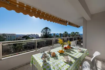a table and chairs on a balcony with a view at 104 sqm Sea-View Apartment Cannes in Cannes