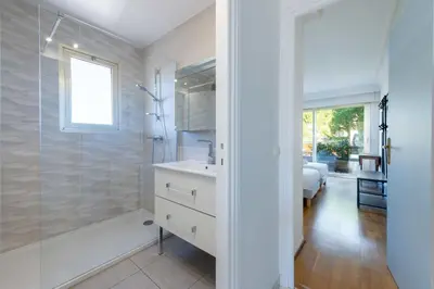a white bathroom with a shower and a sink at 104 sqm Sea-View Apartment Cannes in Cannes