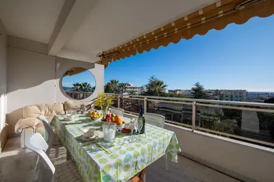 a dining table on a balcony with a view at 104 sqm Sea-View Apartment Cannes in Cannes