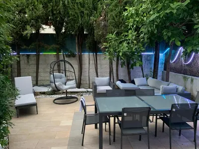 a patio with a table and chairs and a couch at Elegance Cannoise, vaste terrasse in Cannes