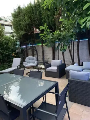 a patio with a glass table and chairs at Elegance Cannoise, vaste terrasse in Cannes