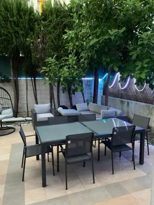 a group of tables and chairs in a patio at Elegance Cannoise, vaste terrasse in Cannes