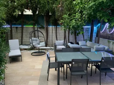 a patio with a table and chairs and a couch at Elegance Cannoise, vaste terrasse in Cannes