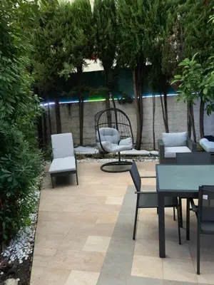 a patio with chairs and tables and a bench at Elegance Cannoise, vaste terrasse in Cannes