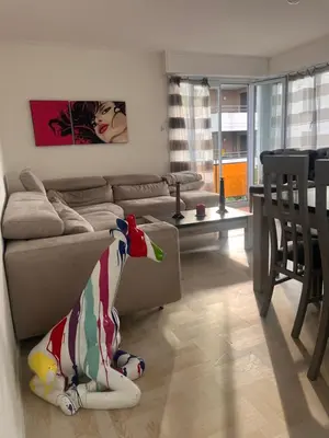 a living room with a couch and a cow toy at Elegance Cannoise, vaste terrasse in Cannes