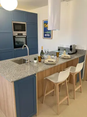 a living room with couches and a table and a kitchen at Townhouse Bellevue in Cannes in Cannes