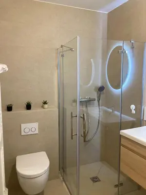 a bathroom with a shower with a toilet and a sink at Townhouse Bellevue in Cannes in Cannes