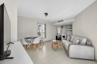 a kitchen with red cabinets and a washer and dryer at F2 quai Saint-Pierre in Cannes