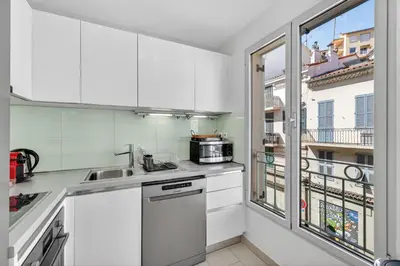 a balcony with a white chair and a table at F2 quai Saint-Pierre in Cannes
