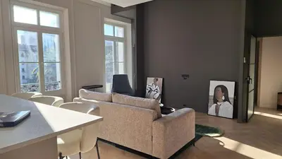 a living room with a couch and a table at first louis marie Beautiful 3 bedrooms elegant and central in Cannes