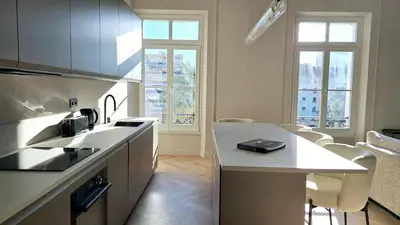 a kitchen with a sink and a counter top at first louis marie Beautiful 3 bedrooms elegant and central in Cannes