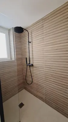 a bathroom with a shower with a glass door at first louis marie Beautiful 3 bedrooms elegant and central in Cannes