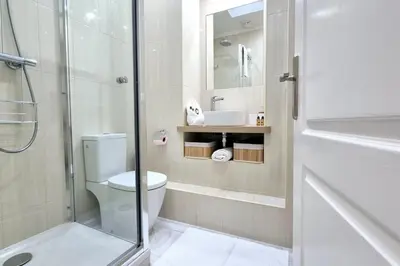 a bathroom with a toilet and a sink and a shower at Charming one-bedroom flat on rue Hoche in Cannes