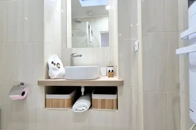 a bathroom with a sink and a mirror at Charming one-bedroom flat on rue Hoche in Cannes