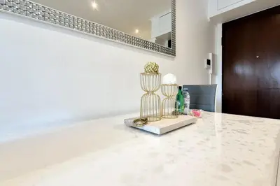 a white room with a table with flowers on it at Charming one-bedroom flat on rue Hoche in Cannes