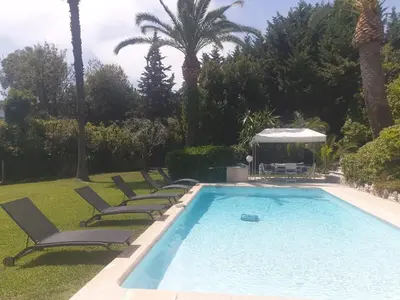 a swimming pool with lounge chairs and a gazebo at Villa Cannes in Cannes