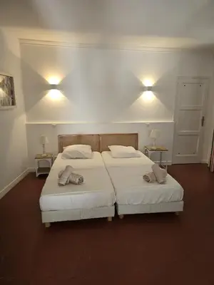 a bedroom with two beds and two lights on the wall at Villa Cannes in Cannes