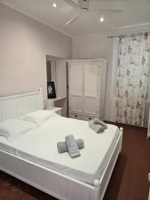 a bedroom with a white bed with towels on it at Villa Cannes in Cannes