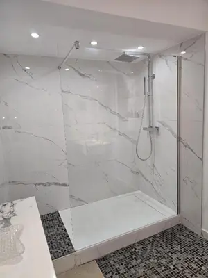 a bathroom with a shower with white marble walls at Villa Cannes in Cannes
