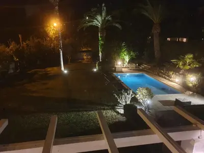a swimming pool in a yard at night at Villa Cannes in Cannes