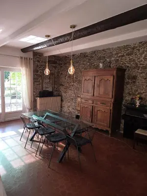 a dining room with a table and chairs and a piano at Villa Cannes in Cannes