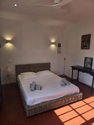 a bedroom with a large bed with two pillows on it at Villa Cannes in Cannes