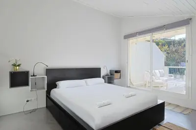 a bedroom with a large bed and a large window at 221 Le Bella in Cannes