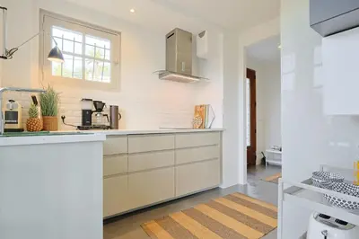 a kitchen with white cabinets and a window at 221 Le Bella in Cannes