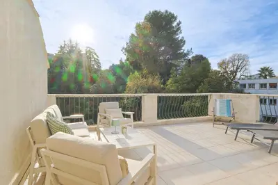 a patio with chairs and a table on a balcony at 221 Le Bella in Cannes