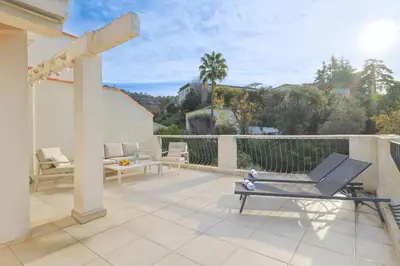 a patio with two chairs and a table on avisor at 221 Le Bella in Cannes
