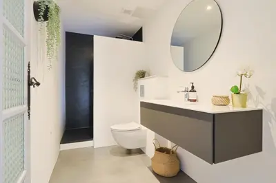 a bathroom with a toilet and a mirror on the wall at 221 Le Bella in Cannes