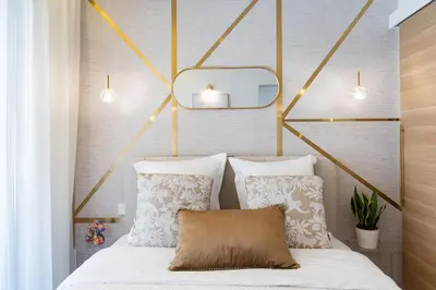 a bedroom with a bed with two pillows and a mirror at Le Charme YourHostHelper in Cannes