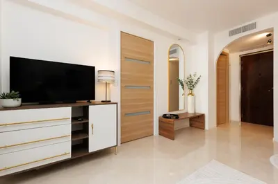 a living room with a television on a dresser at Le Charme YourHostHelper in Cannes
