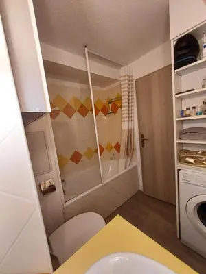 a small kitchen with a sink and a microwave at Cap ô sud 2 in Cannes